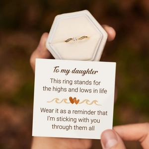 Detail of s925 gold wave ring with double stones and sentimental gift card in velvet box