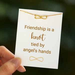 Golden infinity knot necklace on friendship greeting card with angel's hands message