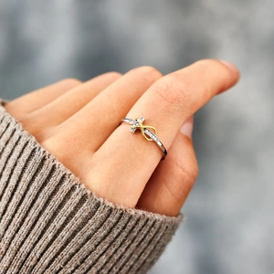 Two-tone S925 silver infinity cross ring with diamonds on a hand model