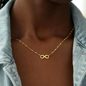 S925 sterling silver infinity necklace with colorful beads on a denim jacket model