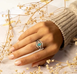 Close-up of S925 silver chevron ring with marquise turquoise and pave-set diamonds