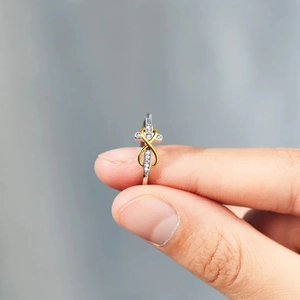 Close-up of S925 silver infinity cross ring with two-tone gold plating and zircon inlay