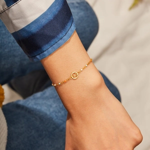 S925 sterling silver infinity bracelet with colorful beads and gold finish on wrist