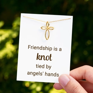 Polished gold S925 sterling silver angel knot necklace on friendship card outdoors