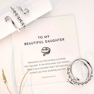 Close-up of S925 sterling silver anxiety ring with rotating beads and gift card for daughter