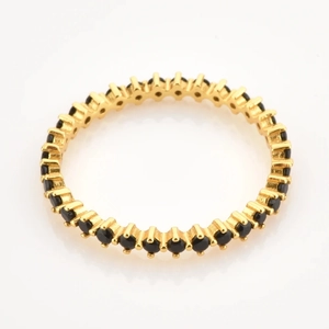 Eternity ring in gold finish featuring a continuous row of micro-paved black zircons