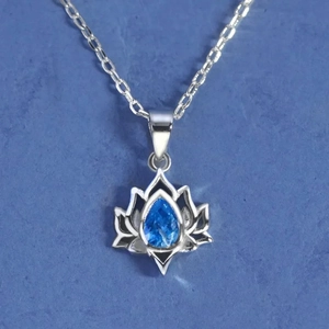 S925 sterling silver lotus necklace with pear-shaped blue gemstone on a blue background
