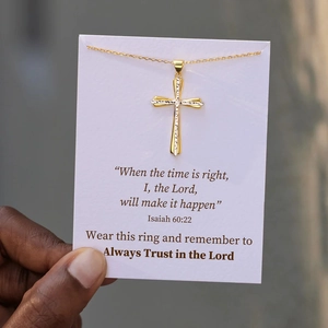 Détail du collier croix bicolore sur une carte avec citation d'Isaïe 60:22
