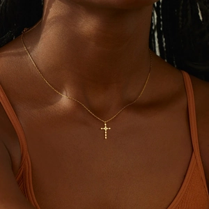 Elegant gold S925 sterling silver cross necklace with sparkling stones on female neck