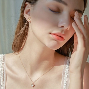 Elegant s925 silver heart opal necklace with micro pave diamonds on a female model