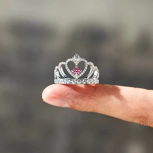 Macro detail of S925 sterling silver crown ring featuring a sparkling pink heart gemstone