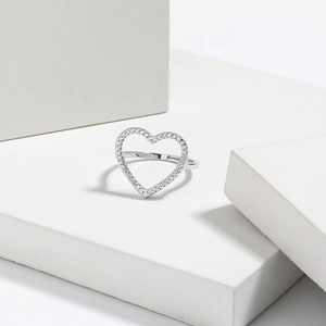 Macro detail of s925 silver heart ring with sparkling pavé zircon stones on white display