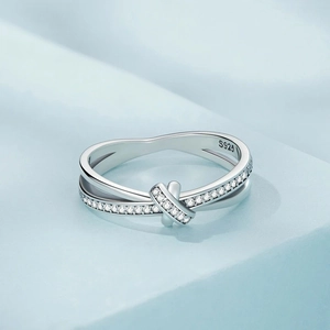 Elegant S925 sterling silver crisscross ring with pavé cubic zirconia on light blue stand