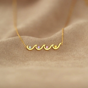 Elegant S925 sterling silver wave necklace with four vibrant birthstones in gold finish