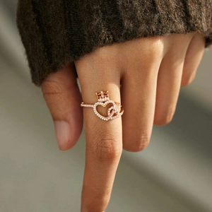 Elegant rose gold princess crown heart ring with sparkling zircons on finger