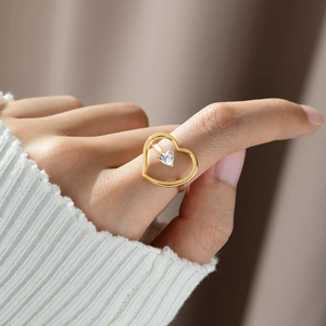 Elegant gold S925 sterling silver hollow heart ring featuring a central zircon stone