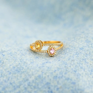 Close-up of double layer silver ring featuring oval yellow and pink birthstones