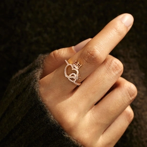 Close-up of rose gold crown and double heart ring with sparkling crystal pave