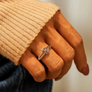 Elegant S925 sterling silver heart knot ring featuring sparkling zircon on hand