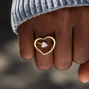 Minimalist S925 silver hollow heart ring with zircon stone shown on finger