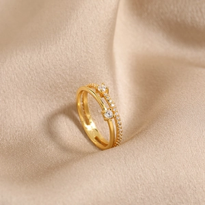 S925 sterling silver double-layer gold ring with diamonds on champagne silk background