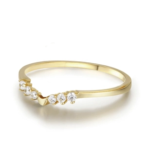 Elegant gold V-shaped chevron ring with six sparkling clear gemstones on white background