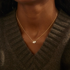 Detailed view of s925 silver double heart pendant necklace with pave diamonds on model