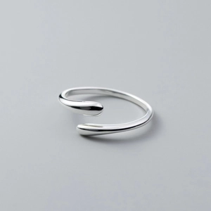 Macro shot of minimalist S925 sterling silver open ring with polished droplet-shaped ends