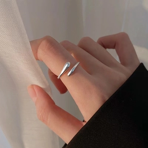 Detailed view of an S925 sterling silver minimalist hug ring worn on the index finger