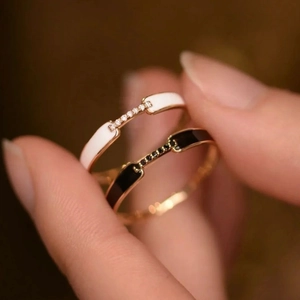 Set of two S925 sterling silver rings with white and black enamel and sparkling pavé stones