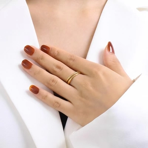 Goldener zweilagiger gedrehter Seilring für Damen am Zeigefinger getragen