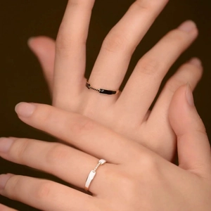 Detail of minimalist S925 silver rings with black and white enamel and pave diamonds