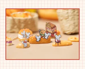 Detailed macro view of miniature resin croissant and cute mouse figurine for DIY decor