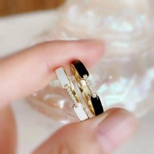 Close-up of black and white enamel rings with pavé cubic zirconia and gold plating