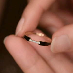 Macro shot of 925 silver ring with black enamel inlay and sparkling zircon pavé