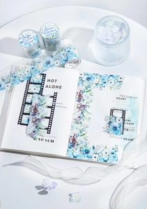 Detail of Snow Garden PET tape showing realistic blue and purple flowers on a planner
