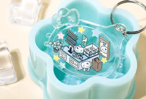 Macro view of cat-shaped acrylic keychain with glitter star sequins and bow detail
