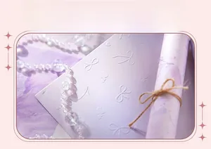 Detailed view of lavender art paper with embossed bow and heart texture patterns