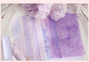 Detailed view of purple marble aesthetic scrapbooking paper with vintage ribbon accents
