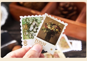 Close-up of vintage oil painting stamp stickers with floral motifs for DIY journals