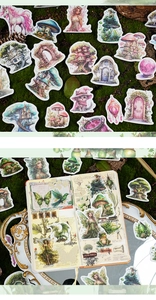Close-up of fairy and dragon stickers on vintage notebook with nature props