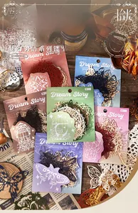 Detail of laser-cut paper scrapbooking materials with vintage butterfly and floral motifs