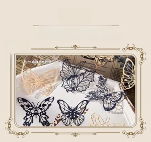 Detailed laser-cut paper butterfly with intricate floral patterns for scrapbooking decor