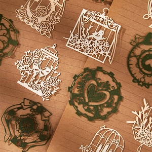 Lace paper ephemera with vintage birdcage and rose cutout designs for scrapbooking