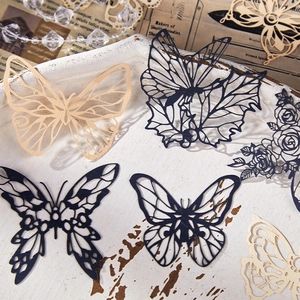 Intricate laser-cut paper butterflies for scrapbooking in white and blue hues
