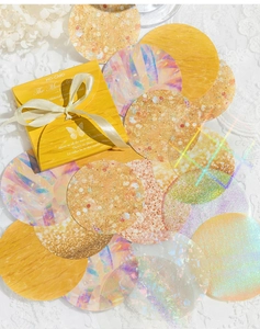 Macro shot of MO-CARD The Moon decorative paper circles with holographic and glitter textures