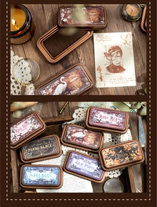 Detail of vintage tin box ink pads with floral illustrations and retro craft accessories