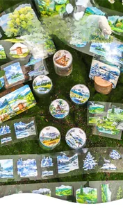 Close-up of PET scenery tape on moss background showing nature landscape illustrations