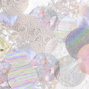 Holographic circular scrapbooking stickers with butterfly designs on white lace background