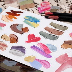 Artistic oil paint stroke stickers with heart shapes on a vintage linen and wood background